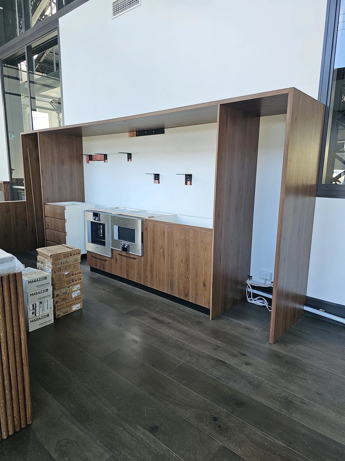 Cabinetry and appliance spaces during installation.