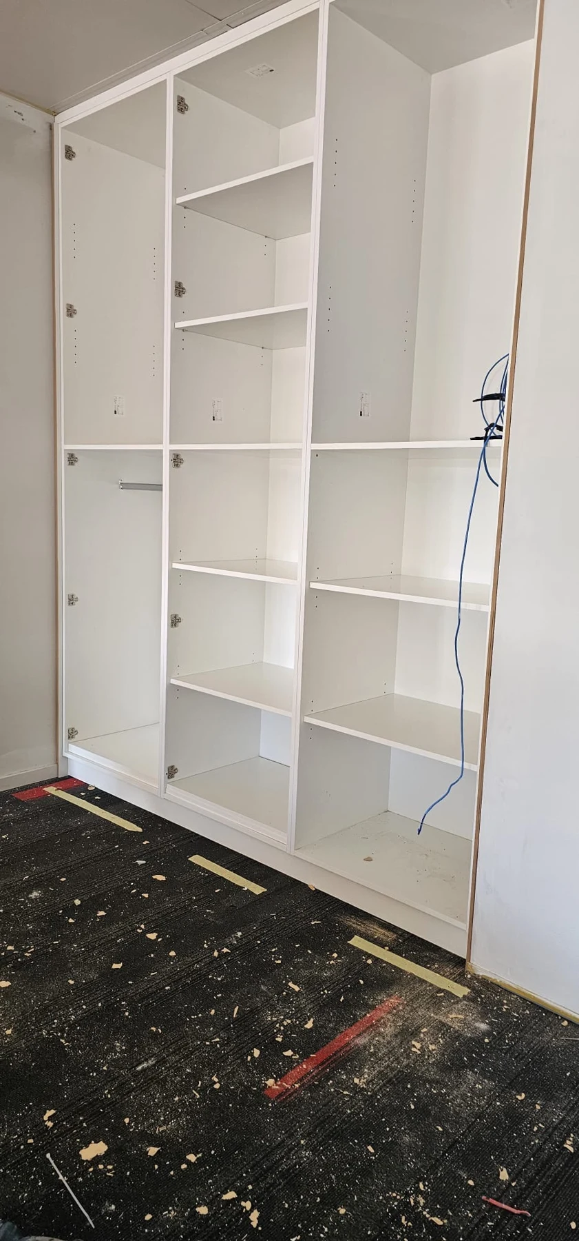 Shelving and storage units during installation.